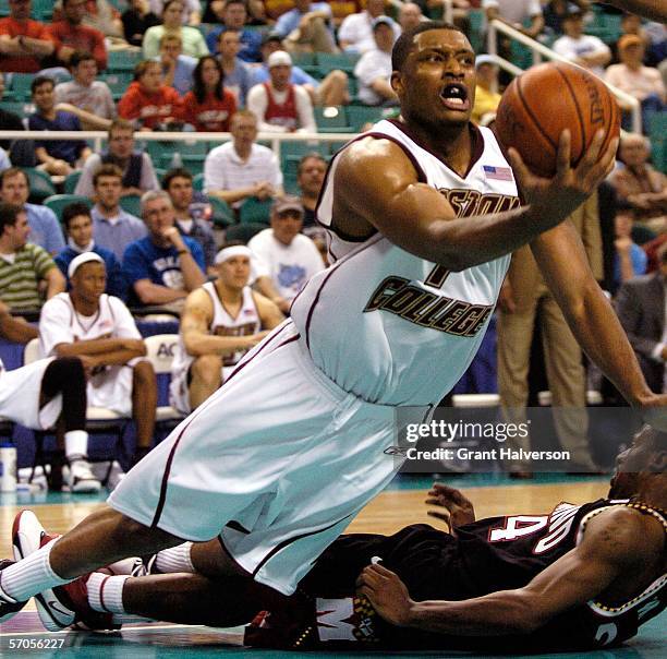 Craig Smith of the Boston College Eagles throws up a shot as he falls after colliding with Travis Garrison of the Maryland Terrapins during the...