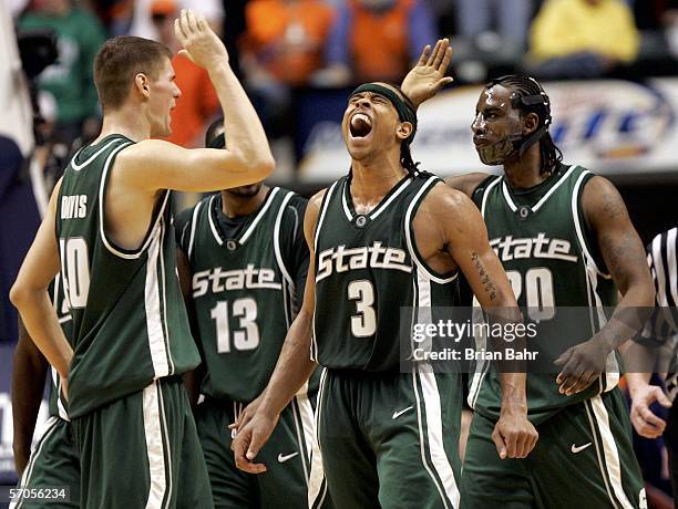 Shannon Brown of the Michigan State Spartans yells as Paul Davis and Matt Trannon give each other a high five in the second half against the Illinois...