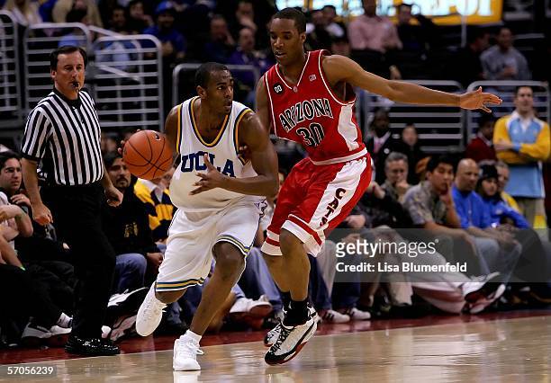 Arron Afflalo of the UCLA Bruins moves the ball past J.P. Prince of the Arizona Wildcats during the semifinals of the 2006 Pacific Life Pac-10 Men's...