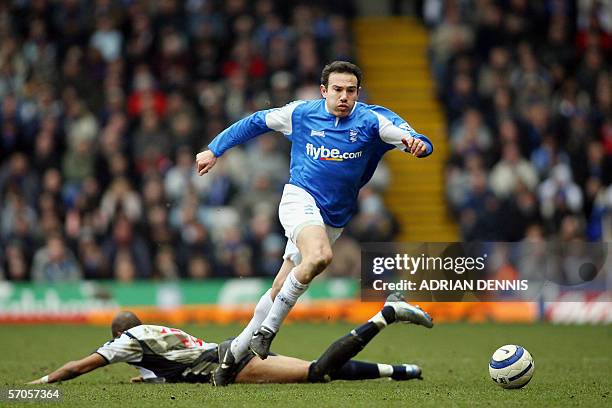 Birmingham, UNITED KINGDOM: Birmingham City's Stan Lazaridis skips over a tackle from Diomansy Kamara of West Bromwich Albion during the Premiership...