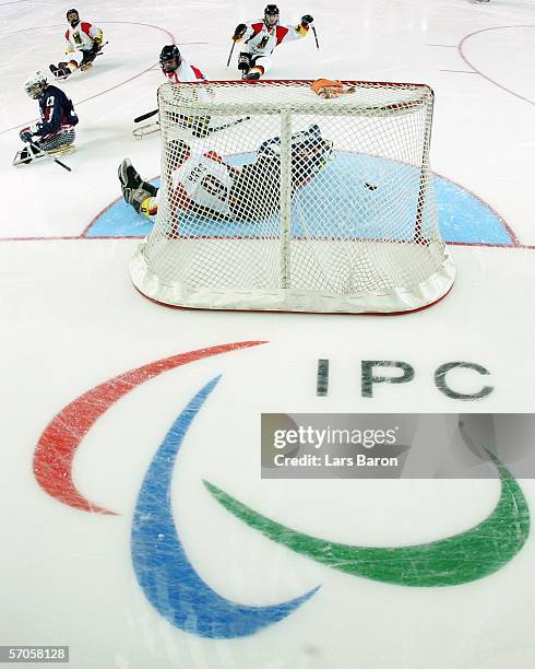 Joseph Howard of USA scores the third goal during a sledge hockey preliminary round Group B match between USA and Germany on day one of the Turin...