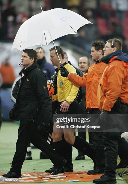 The security shields referee Peter Gagelmann after the Bundesliga match between 1. FC Cologne and 1. FC Nuremberg at the Rhein Energie Stadium on...