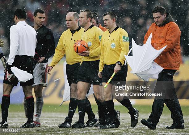 The security shields referee Peter Gagelmann and his assistants Matthias Anklam and Dirk Margenberg after the Bundesliga match between 1. FC Cologne...
