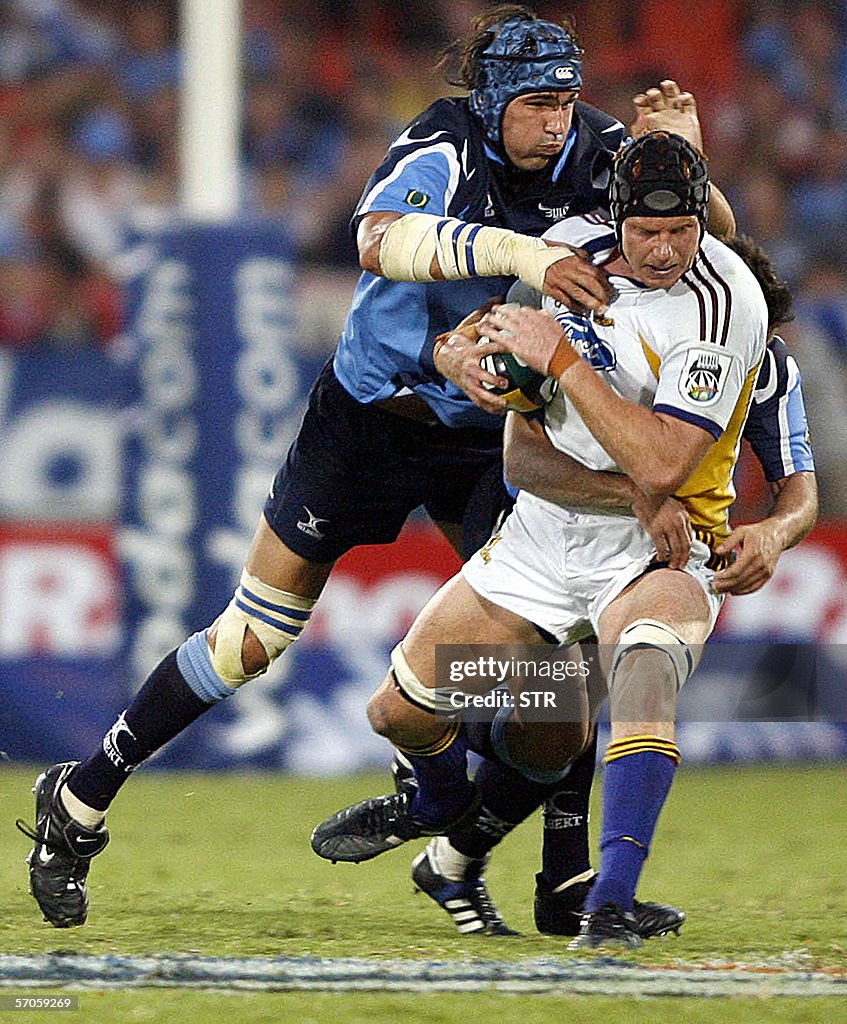 James Rryan James Ryan of Highlanders gets a tackled from Victor Matfield of Blue ...