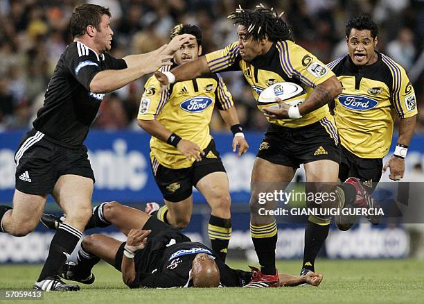 Cape Town, SOUTH AFRICA: Hurricanes centre Ma'a nonu pushes back Stormers flank Luke Watson , 11 March 2006, as he is followed by his teammates...