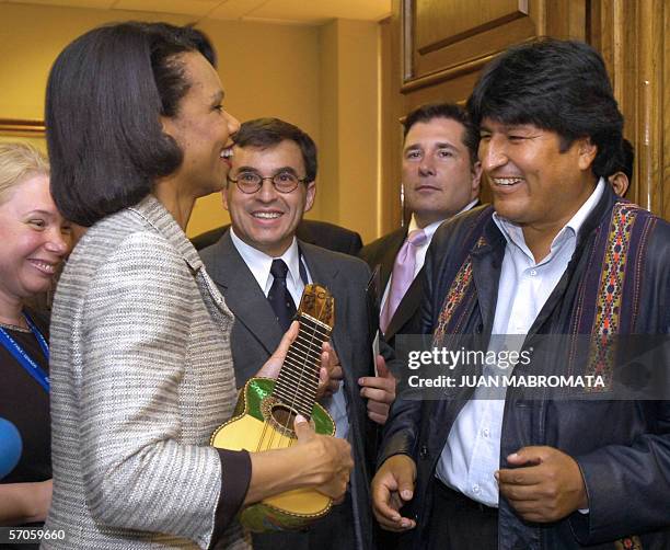 Secretary of State Condoleezza Rice plays with a "charango" she received from Bolivian President Evo Morales during a meeting 11 March, 2006 at the...