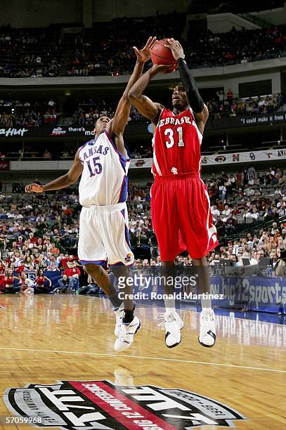 Jamel White of the Nebraska Cornhuskers shoots the jump shot against Mario Chalmers of the Kansas Jayhawks during the semifinals round of the...