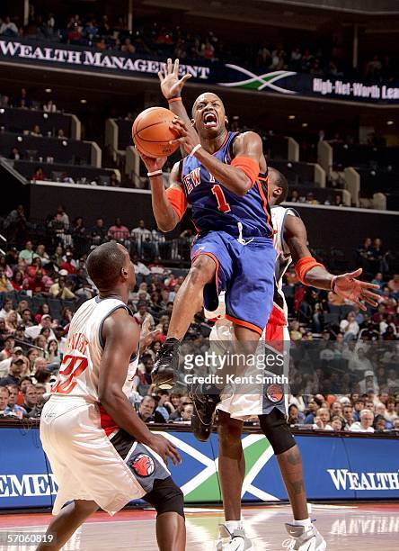 Steve Francis of the New York Knicks shoots over Brevin Knight of the Charlotte Bobcats on March 11, 2006 at the Charlotte Bobcats Arena in...