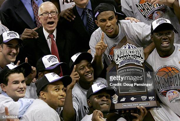 Head coach Steve Fisher and the San Diego State University Aztecs pose with the trophy after defeating the Wyoming Cowboys 69-64 in the championship...