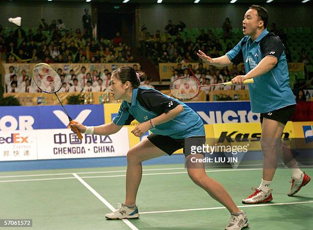 Zhang Jun of China serves with Gao Ling against their compatriot Xie Zhongbo and Zhang Yawen during the mixed doubles final of Aviva-Cofco China...