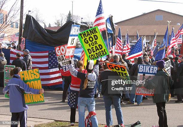 Flushing, UNITED STATES: HECKLERS HARASS FAMILIES OF US SOLDIERS KILLED IN IRAQ: Members of the Kansas-based Westboro Baptist Church wave signs in...