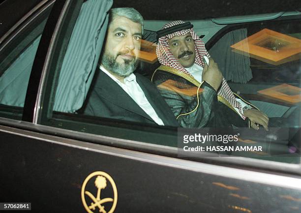 Hamas leader Khaled Meshaal arrives with an unidentified Saudi official a conference palace in Riyadh, 12 March 2006. A visiting Hamas delegation...