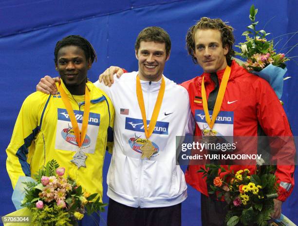 Moscow, RUSSIAN FEDERATION: Sweden's Alhaji Jeng , USA's Brad Walker and German Tim Lobinger celebrate on the winners' podium of the men's pole vault...