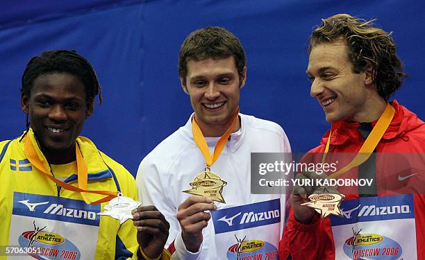 Moscow, RUSSIAN FEDERATION: Sweden's Alhaji Jeng , USA's Brad Walker and German Tim Lobinger celebrate on the winners' podium of the men's pole vault...