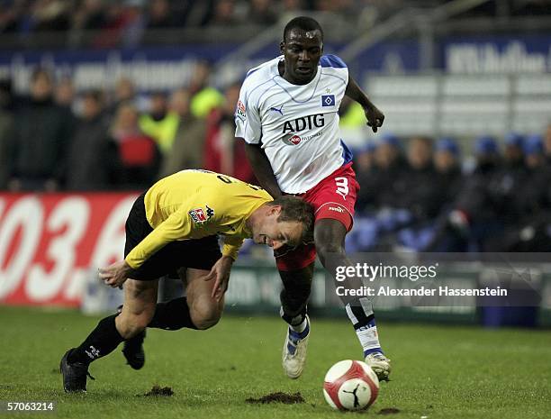 Jon Inge Hoiland of Kaiserslautern, challenge for the ball with Thimothee Atouba of Hamburg during the Bundesliga match between Hamburger SV and 1....