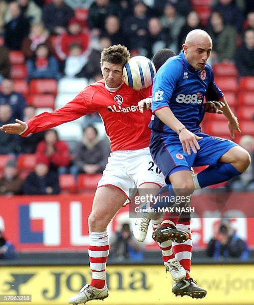 London, UNITED KINGDOM: Charlton's English midfielder Bryan Hughes and Middlesbrough's Italian forward Massimo Maccarone collide as they jump for the...