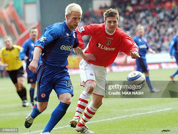 London, UNITED KINGDOM: Charlton's English midfielder Bryan Hughes and Middlesbrough's Andrew Davies run for the ball during their English...