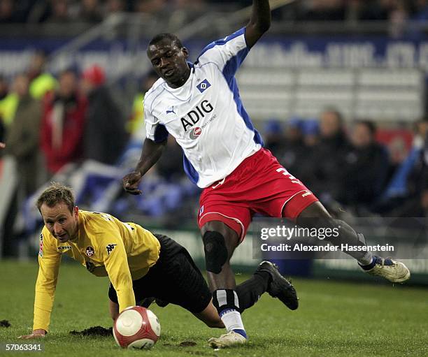 Jon Inge Hoiland of Kaiserslautern, fights for the ball with Thimothee Atouba of Hamburg during the Bundesliga match between Hamburger SV and 1. FC...