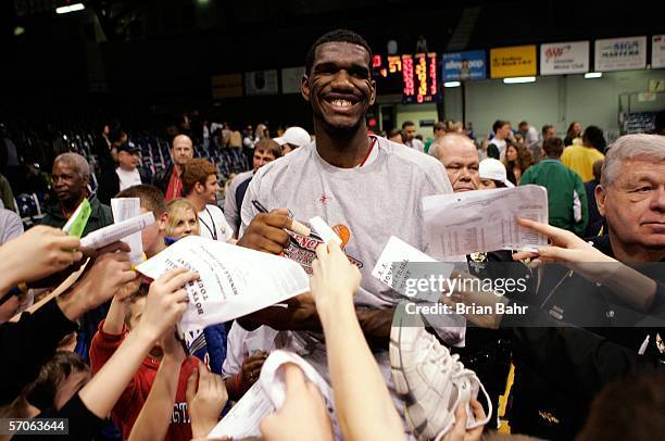 Greg Oden of the Lawrence North Wildcats signs autographs from fans after the game against the Pike Red Devils in the I.H.S.A.A. 4A Regional Boys'...