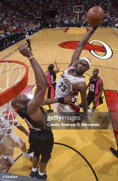 LeBron James of the Cleveland Cavaliers goes up for the dunk over Alonzo Mourning of the Miami Heat on March 12, 2006 at American Airlines Arena in...