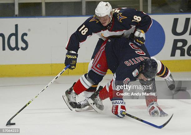 Darius Kasparaitis of the New York Rangers throws a hip check against Marian Hossa of the Atlanta Thrashers at Madison Square Garden on March 12,...