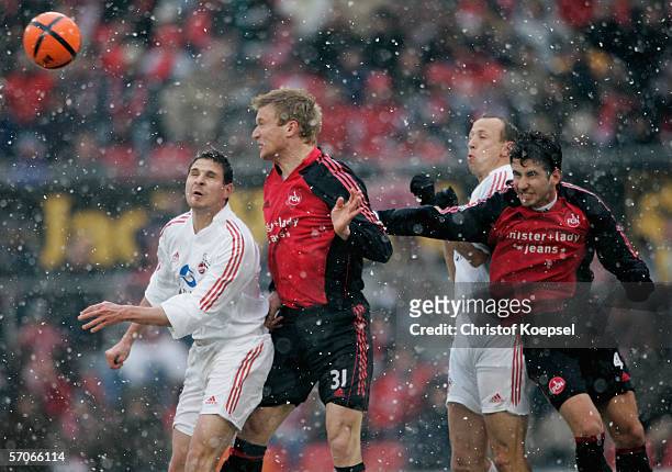 Imre Szabics of Cologne and Thomas Paulus of Nuremberg go up for a header during the Bundesliga match between 1. FC Cologne and 1. FC Nuremberg at...