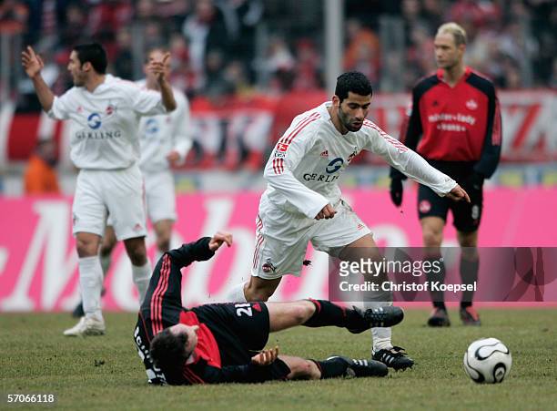 Markus Schroth of Nuremberg tackles Dimiotrios Grammozis of Colgne during the Bundesliga match between 1. FC Cologne and 1. FC Nuremberg at the Rhein...