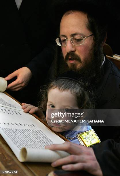 Ultra Orthodox Jews from the Wiznitz Hassidim group reads the Ester scrolls at the synagogue in the Israeli town of Beni Brak near Tel Aviv 13 March...