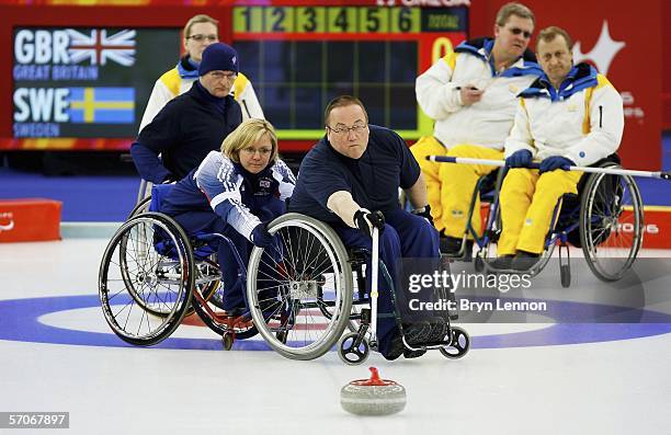 Angie Malone of Great Britain team mate Tom Killin as he releases the stone during Wheelchair Curling match between Great Britain and Sweden on day...