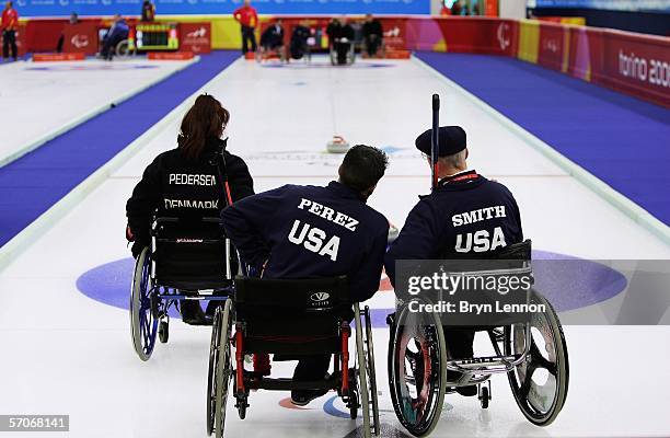 Wes Smith of the USA chats to team mate Augusto Perez during the Wheelchair Curling match between the USA and Denmark on day three of the Turin 2006...