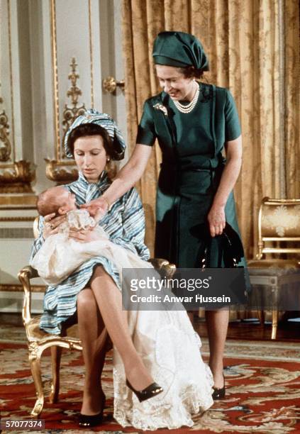 Queen Elizabeth II with Princess Anne and her first grandchild, Peter Phillips, pose for a photograph on November 20, 1977 at Balmoral, England.