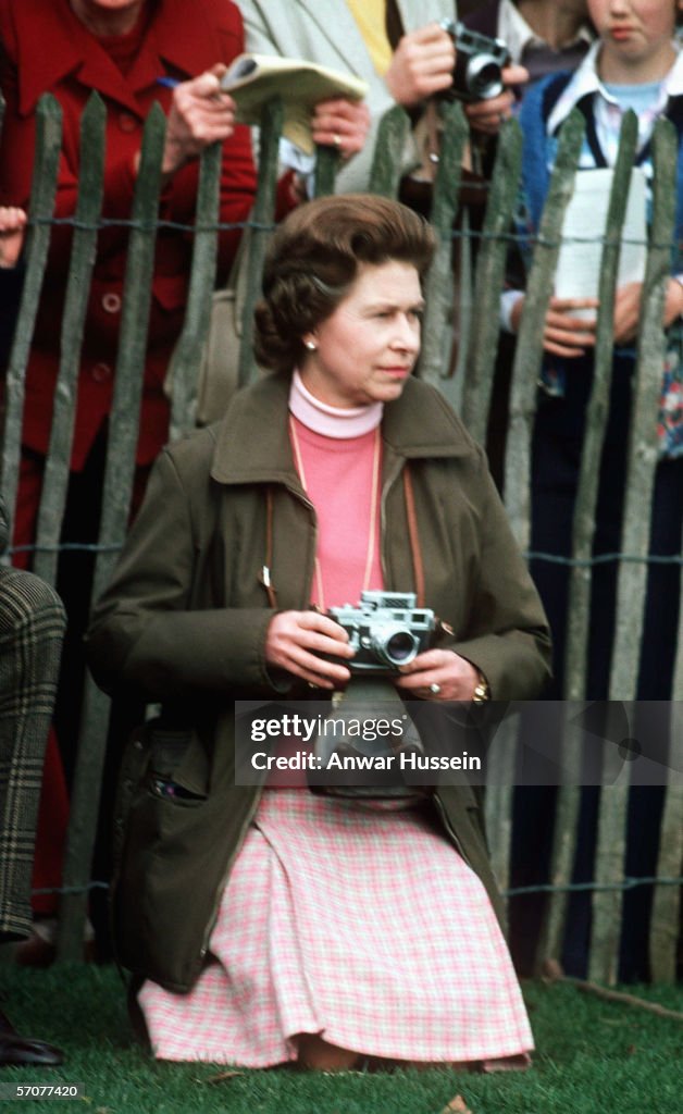 Queen Elizabeth II kneels down with a camera and watches the... News ...