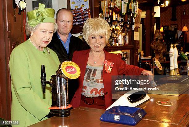 Queen Elizabeth II visits Elstree Studios where the famous British soap opera EastEnders is filmed, on November 28, 2001 in London, England. During...