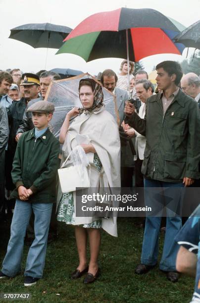 Queen Elizabeth II with Princes Andrew and Edward watch Princess Anne compete in the Equestrian event at the 1976 Summer Olympics on July 23, 1976 in...