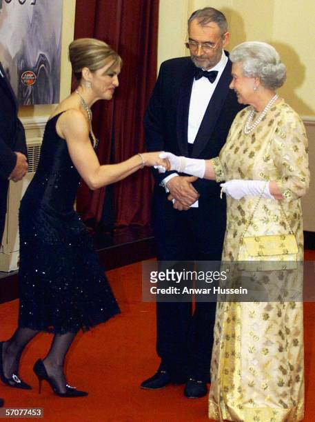 Queen Elizabeth II meets pop star and actress Madonna watched by producer Michael Wilson at the world premiere of the James Bond movie "Die Another...