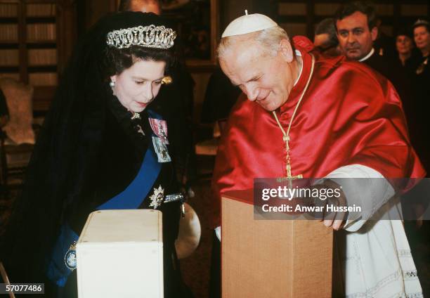 Pope John Paul II meets Queen Elizabeth II exchange gifts at the Vatican, Rome, Italy on the 17th of October 1980.