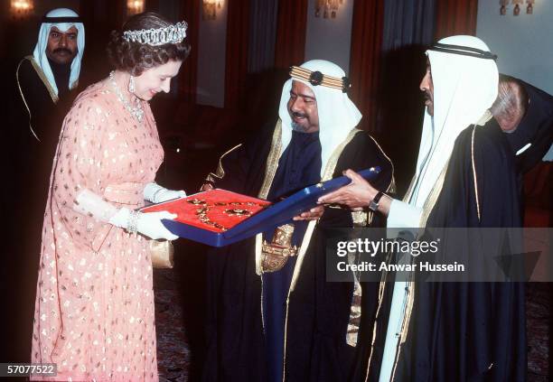 Queen Elizabeth II receives a gift from the Amir of Bahrain during her tour of the Middle East in February 1979.