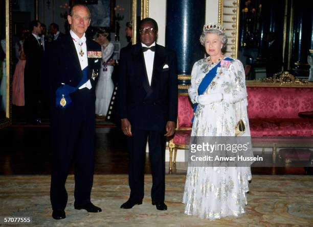 President Robert Mugabe of Zimbabwe is greeted by Queen Elizabeth ll and Prince Phillip the Duke of Edinburgh at Buckingham Palace,London during his...