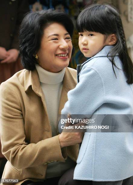 Japanese Crown Princess Masako soothes her daughter Princess Aiko as they are welcomed by Disney charactors upon arrival at Tokyo DisneySea in...