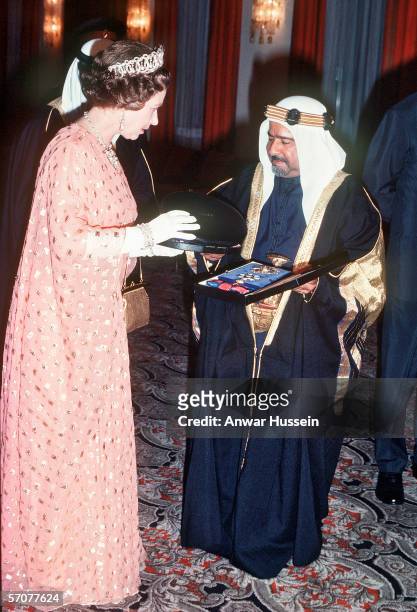 Queen Elizabeth II receives a gift from the Amir of Bahrain during her tour of the Middle East in February 1979.