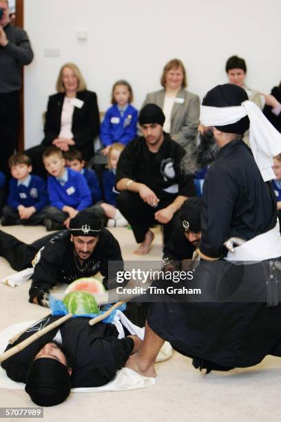 Swordsmen display Gatka, a traditional Sikh martial art at the Gurdwara Sri Guru Singh Sabha Temple as a blindfolded swordsman chops a melon on a...