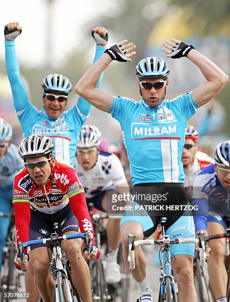 San Benedetto del Tronto, ITALY: Italian Alessandro Petacchi flanked by teammate German Erik Zabel , raises his arms as he crosses the finish line of...