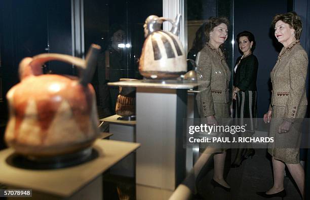 Washington, UNITED STATES: US First Lady Laura Bush is reflected in a display case as, Mexican First Lady Marta Sahagun de Fox watches during a tour...