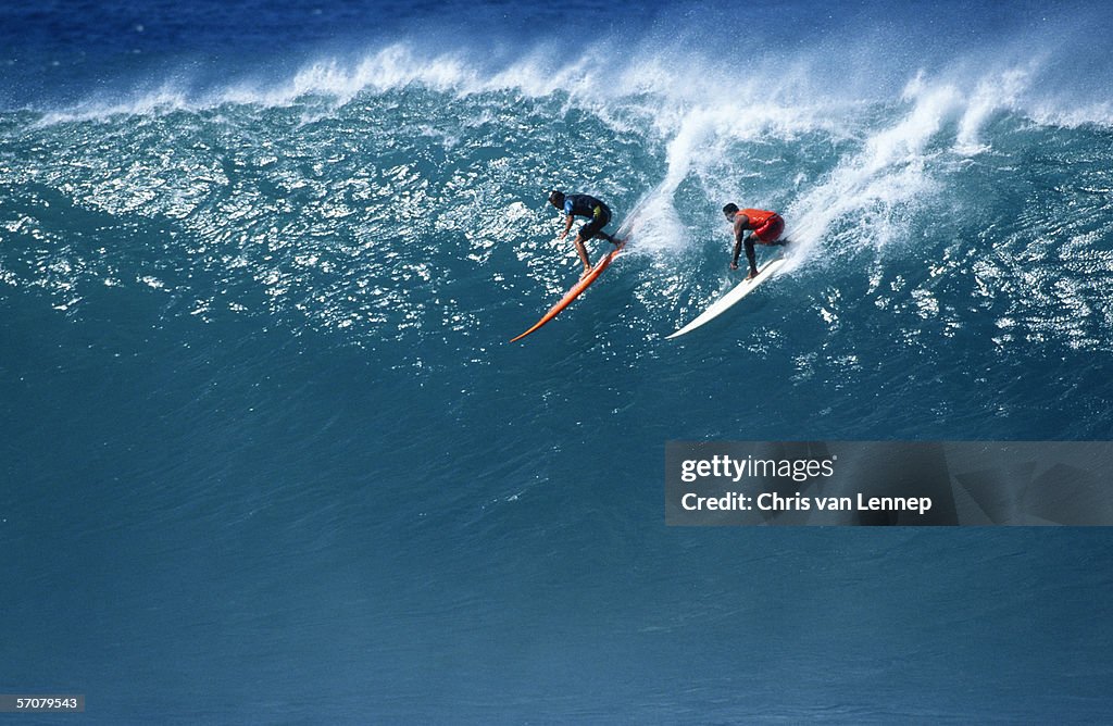 Two Surfers Riding a Huge Wave