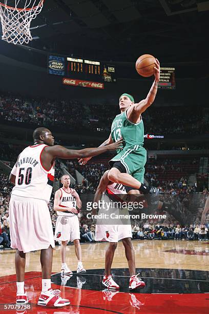 Delonte West of the Boston Celtics goes to the basket against Zach Randolph of the Portland Trail Blazers during the game at the Rose Garden on...