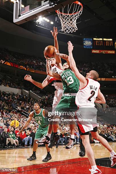 Delonte West of the Boston Celtics goes to the basket against Viktor Khryapa and Steve Blake of the Portland Trail Blazers during the game at the...