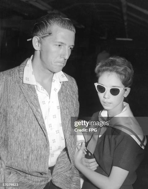 American rock and roll piano pioneer Jerry Lee Lewis with his second cousin and third wife at the airport as they prepare to leave the United Kingdom...