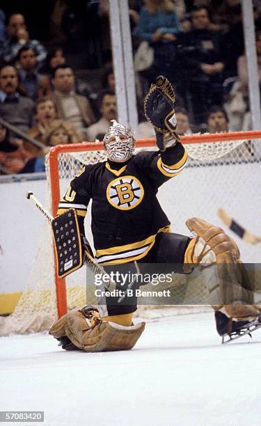 Canadian professional hockey player Gerry Cheevers of the Boston Bruins defends the goal on the ice during a road game, late 1970s.