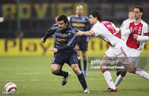 Luis Figo of Inter sidesteps past Nourdin Boukhari of Ajax during the UEFA Champions League First Knock-out Round 2nd Leg match between Inter Milan...