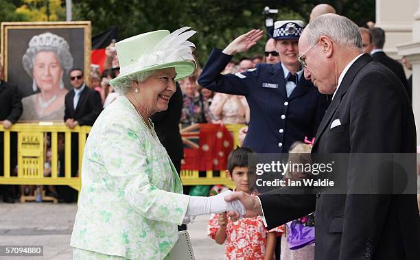 Her Majesty The Queen meets Australian Prime Minister John Howard as she arrives at a luncheon March 15, 2006 in Melbourne, Australia. The Queen is...